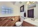 Bathroom with wood-paneled walls and large mirror at 12263 Clermont Ct, Thornton, CO 80241