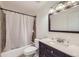 Clean bathroom with tub shower and dark vanity at 12263 Clermont Ct, Thornton, CO 80241