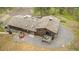 Aerial view of a brown home with a stone chimney, multiple skylights, and a backyard deck at 2013 Swede Gulch Rd, Evergreen, CO 80439