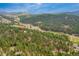 Mountain home surrounded by lush forestry with views of rolling hills at 2013 Swede Gulch Rd, Evergreen, CO 80439