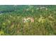 Expansive aerial view of a wooded property showcasing the home's secluded location at 2013 Swede Gulch Rd, Evergreen, CO 80439