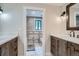 A stylish bathroom features a double vanity with stone countertops, decorative tile accents, and modern fixtures at 2013 Swede Gulch Rd, Evergreen, CO 80439