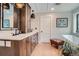 Beautiful bathroom with soaking tub, natural stone floors, dark wood cabinets, and stone countertops at 2013 Swede Gulch Rd, Evergreen, CO 80439