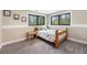 Cozy bedroom with natural light, carpet, and large windows overlooking the surrounding greenery at 2013 Swede Gulch Rd, Evergreen, CO 80439