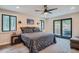 Primary bedroom with slider access to deck, ceiling fan, and generous natural light at 2013 Swede Gulch Rd, Evergreen, CO 80439
