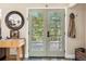 Inviting entryway featuring a glass panel door that provides natural light and view of outdoors at 2013 Swede Gulch Rd, Evergreen, CO 80439