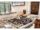 Close-up of the kitchen featuring a gas stove and cooktop with granite countertops at 2013 Swede Gulch Rd, Evergreen, CO 80439