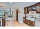 Open kitchen with a farmhouse sink, wood cabinets, granite counters, and a sliding barn door at 2013 Swede Gulch Rd, Evergreen, CO 80439