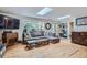 Living room featuring hardwood floors, a grey sofa, skylights and a big window at 2013 Swede Gulch Rd, Evergreen, CO 80439