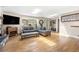 Bright living room with hardwood floors, skylights, and large windows offering scenic views at 2013 Swede Gulch Rd, Evergreen, CO 80439