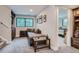 Cozy living room with comfortable seating, natural light, and access to adjacent bedroom at 2013 Swede Gulch Rd, Evergreen, CO 80439