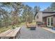 Outdoor patio area with wood table, fire pit and gravel groundcover at 2013 Swede Gulch Rd, Evergreen, CO 80439