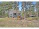 A gray storage shed surrounded by mature trees offers ample space for outdoor tools and equipment at 2013 Swede Gulch Rd, Evergreen, CO 80439