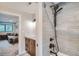 Modern shower with gray tile surround, bronze shower fixtures, and a glass door open to another room at 2013 Swede Gulch Rd, Evergreen, CO 80439