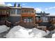 Exterior view of a modern condo with snowy landscape and wooden balconies at 147 Illinois Gulch Rd # 4, Breckenridge, CO 80424