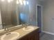 A bathroom with a large mirror and a double sink vanity at 9768 Mayfair St # E, Englewood, CO 80112