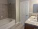 A bathroom with a tile shower and a double sink vanity at 9768 Mayfair St # E, Englewood, CO 80112