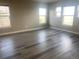 A bedroom with lots of light from the three windows and hardwood floors at 9768 Mayfair St # E, Englewood, CO 80112