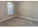 Clean bedroom featuring luxury vinyl plank flooring and a single window to let in natural light at 9768 Mayfair St # E, Englewood, CO 80112
