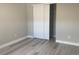 This is a bedroom featuring a closet and light gray vinyl flooring throughout the space at 9768 Mayfair St # E, Englewood, CO 80112
