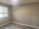 Bright bedroom features a light shade of paint and light gray vinyl flooring at 9768 Mayfair St # E, Englewood, CO 80112
