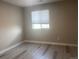 Bright bedroom features a light shade of paint and light gray vinyl flooring at 9768 Mayfair St # E, Englewood, CO 80112