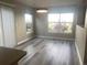 Dining area featuring luxury vinyl plank flooring, two windows, and a modern light fixture at 9768 Mayfair St # E, Englewood, CO 80112