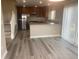 Modern kitchen with stainless steel appliances, wood cabinets, granite countertops, and luxury vinyl plank flooring at 9768 Mayfair St # E, Englewood, CO 80112