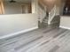 Spacious living room featuring luxury vinyl plank flooring, neutral paint, and a staircase to the second floor at 9768 Mayfair St # E, Englewood, CO 80112