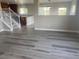 Bright and airy living room featuring luxury vinyl plank flooring and an open floorplan adjacent to the kitchen at 9768 Mayfair St # E, Englewood, CO 80112