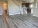 Bright and airy living room featuring luxury vinyl plank flooring and an open staircase to the second floor at 9768 Mayfair St # E, Englewood, CO 80112