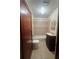 A bathroom featuring a vanity, tiled shower, and a toilet, with neutral tile flooring at 698 S 2Nd Ave, Brighton, CO 80601