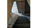 View of a stairway with carpeted steps and walls made of brick and concrete at 698 S 2Nd Ave, Brighton, CO 80601