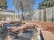 Landscaped backyard with a brick retaining wall and a paved pathway at 1490 S Iris St, Lakewood, CO 80232