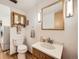 Clean basement bathroom with wood vanity and a large mirror at 1490 S Iris St, Lakewood, CO 80232