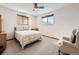 Spacious bedroom with a ceiling fan and a comfortable armchair at 1490 S Iris St, Lakewood, CO 80232