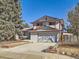 Two-story house with attached garage and mature landscaping at 1490 S Iris St, Lakewood, CO 80232