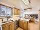 Kitchen features stainless steel appliances and an island at 1490 S Iris St, Lakewood, CO 80232