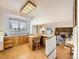 Bright kitchen features wood cabinets, ample counter space, and a view from the window at 1490 S Iris St, Lakewood, CO 80232