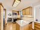 Kitchen with wood cabinets, stainless steel appliances, and island at 1490 S Iris St, Lakewood, CO 80232