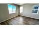 Bedroom with wood floor, large windows, and neutral paint for a calm atmosphere at 2283 Serenidad St, Brighton, CO 80601