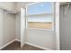 Walk-in closet with built-in shelving and natural light from the upper and lower windows at 2283 Serenidad St, Brighton, CO 80601