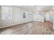 Bright and airy living room boasting expansive windows and elegant wood-style flooring at 2283 Serenidad St, Brighton, CO 80601