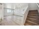 Spacious living room with staircase, offering ample natural light and modern wood floors at 2283 Serenidad St, Brighton, CO 80601