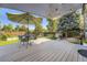 Enjoyable backyard deck area with umbrella, outdoor dining and a peaceful garden view at 5327 Suffolk Cir, Castle Rock, CO 80104