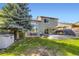 Large backyard features a deck, stone patio, mature trees, and outdoor furniture, ideal for relaxing and entertaining at 5327 Suffolk Cir, Castle Rock, CO 80104