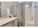 White bathroom featuring a shower over tub with shower curtain, vanity, and mirror at 5327 Suffolk Cir, Castle Rock, CO 80104