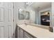 Bright bathroom featuring a long vanity, mirror, and view into primary bedroom at 5327 Suffolk Cir, Castle Rock, CO 80104