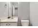 Clean half bathroom with a sink, toilet, and mirror at 5327 Suffolk Cir, Castle Rock, CO 80104