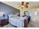 Comfortable primary bedroom with large dresser, wood furniture, neutral carpet and bedding at 5327 Suffolk Cir, Castle Rock, CO 80104